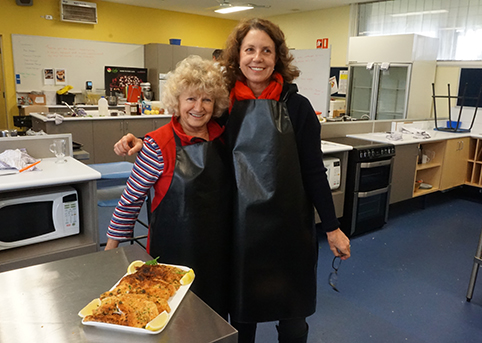 Home Economic teachers and teaching assistants cooking up a seafood spectacular with the help of chef Stuart Laws.
