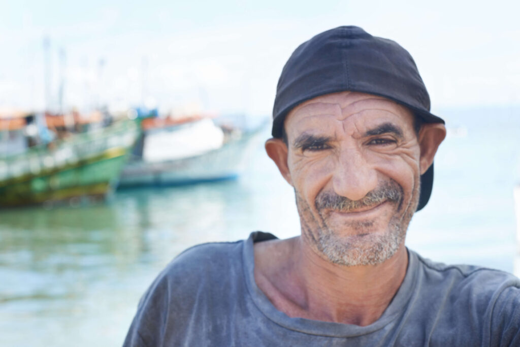 smiling-man-near-boats-on-the-water-2026-03-25-05-06-11-utc (1)