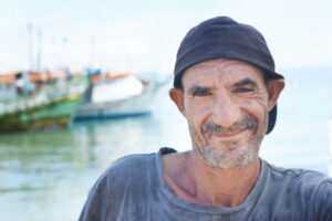 smiling-man-near-boats-on-the-water-2026-03-25-05-06-11-utc (1)